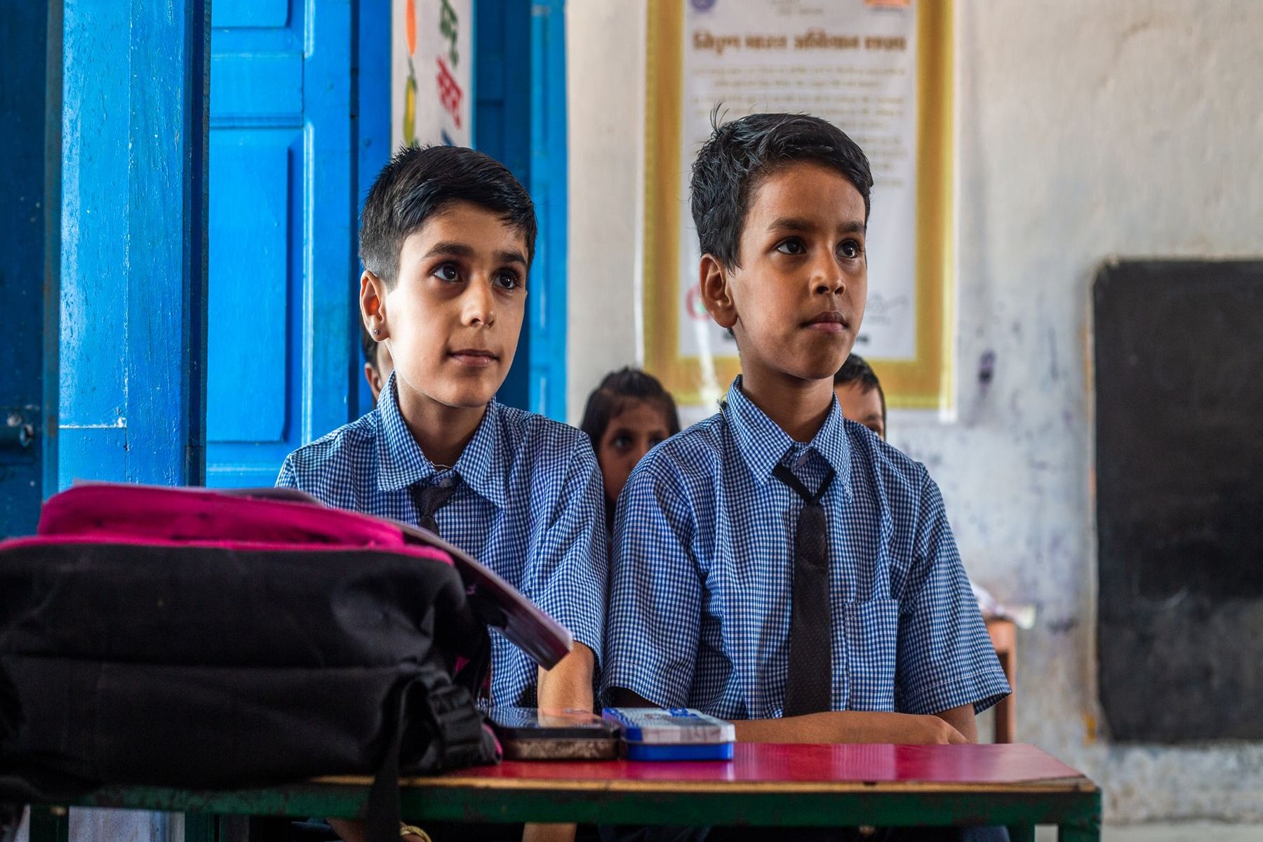 Students focused on classwork in a bright classroom